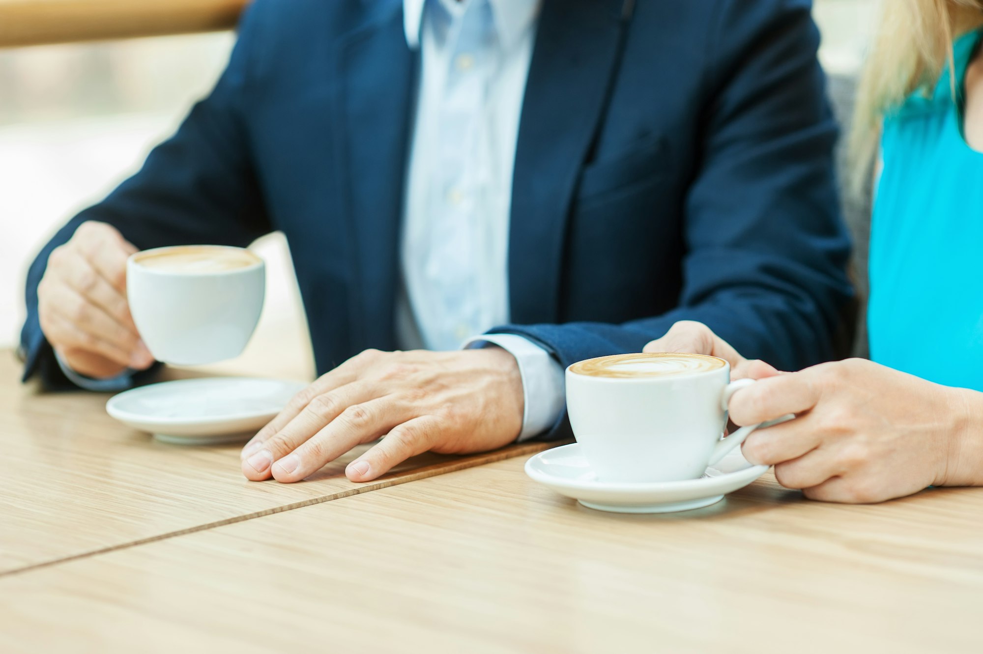 Couple in coffee shop. Top view of couple drinking coffee together while sitting in coffee shop